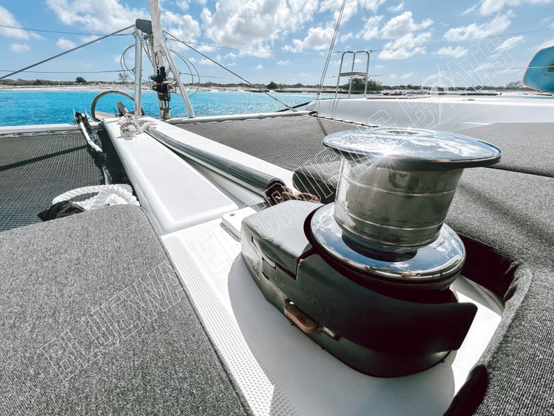 Bow view of a used 2018 Lagoon 42-2 featuring a polished winch and spacious deck, ideal for sailing enthusiasts.