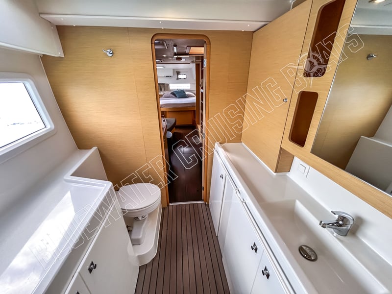 Modern master suite of a 2018 Lagoon 42-2 featuring sleek cabinetry, a spacious head, and elegant finishes in a used condition.