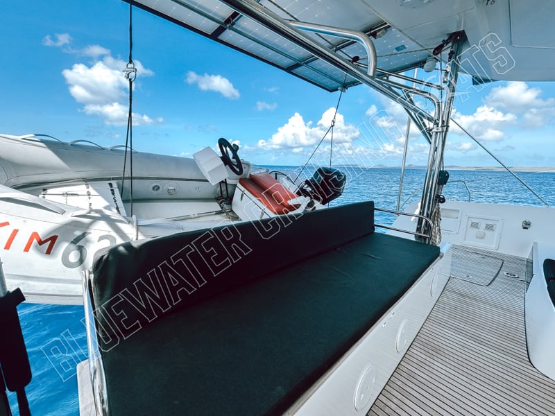 Comfortable saloon area of a 2018 Lagoon 42-2 with a spacious seating arrangement and helm station, featuring sleek design and marine-grade materials.