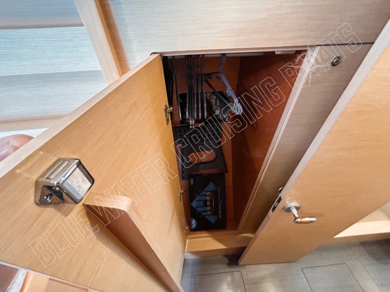 Interior view of the guest stateroom (port aft) in a used 2018 Lagoon 42-2, showcasing a storage cabinet with organized equipment.